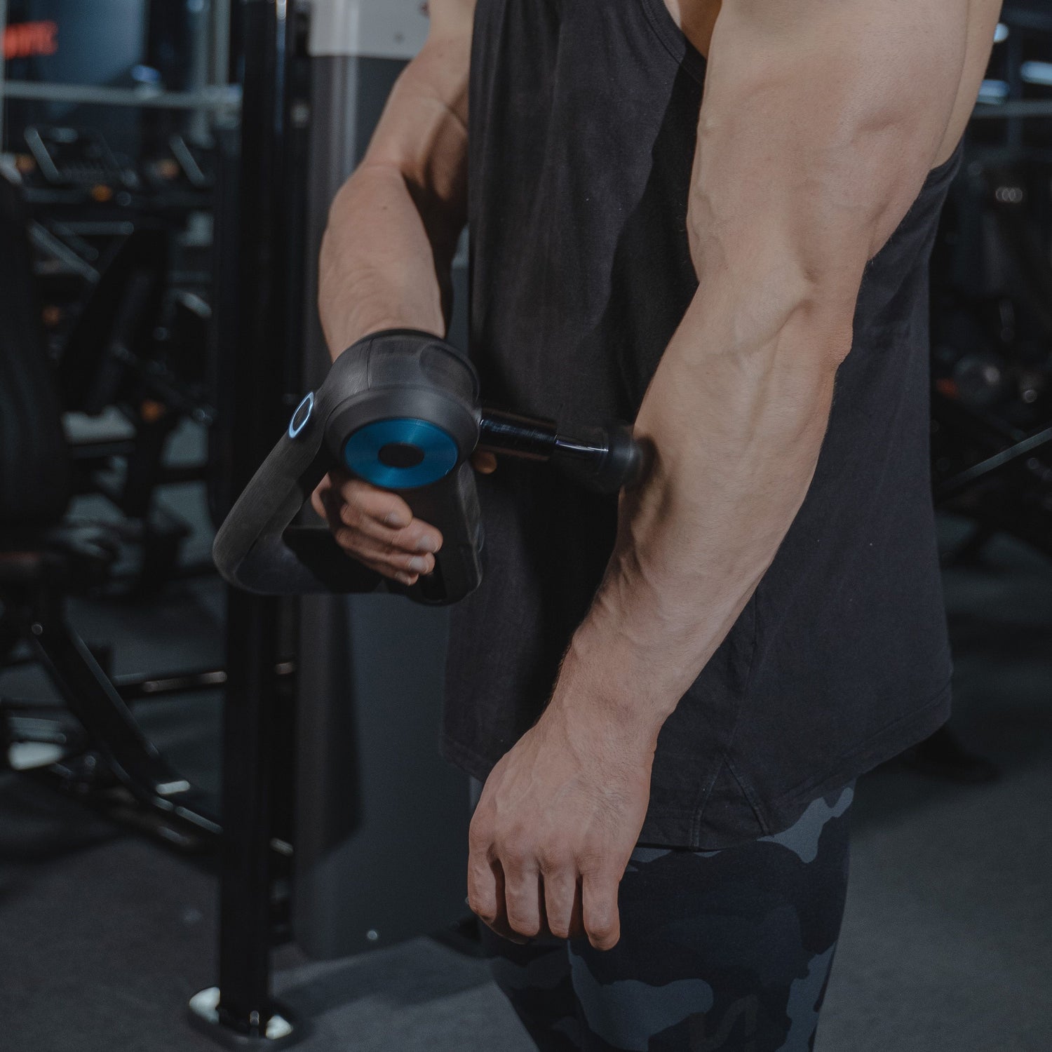 Muscular man in a gym holding a weight plate